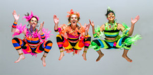 Three dancers jumping high in the air