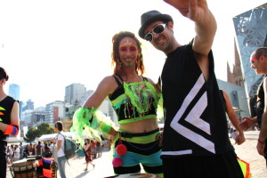 Dancer standing next to drummer with view of Melbourne city behind